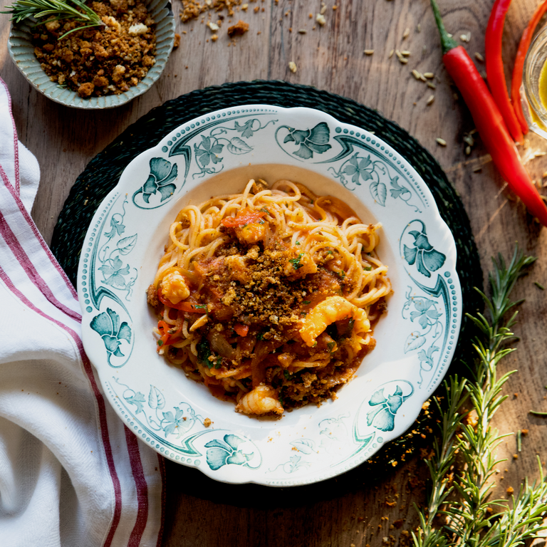 Spaghetti with prawns, langoustine sauce, caramelised shallots & herb pangrattato